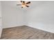 Clean, minimalist bedroom featuring modern floors, a ceiling fan, and abundant natural light at 559 Juniper Springs Dr, Groveland, FL 34736