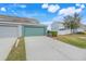 Townhome exterior showcasing a two-car garage and well-maintained landscaping at 559 Juniper Springs Dr, Groveland, FL 34736