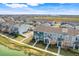 Exterior shot of well-maintained townhomes with landscaping, sidewalks and close proximity to a waterway at 559 Juniper Springs Dr, Groveland, FL 34736