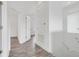 Hallway with wood-look floor and neutral paint; offers access to rooms throughout the house at 559 Juniper Springs Dr, Groveland, FL 34736