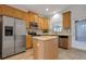 Modern kitchen featuring stainless steel appliances, an island, and a backyard view at 559 Juniper Springs Dr, Groveland, FL 34736