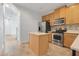 Spacious kitchen featuring stainless steel appliances, wooden cabinets, and an island at 559 Juniper Springs Dr, Groveland, FL 34736