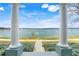 A serene lake view framed by pillars on a sunny day offers a tranquil and picturesque setting at 559 Juniper Springs Dr, Groveland, FL 34736