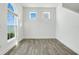 Bright living room featuring wood-look floors, neutral paint, and natural light from a large window with lake view at 559 Juniper Springs Dr, Groveland, FL 34736