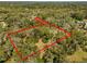 Aerial view of the land surrounded by mature trees and bordered by red lines at 580 Mercers Fernery Rd., Deland, FL 32720