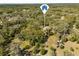 Aerial view of home with a long driveway surrounded by lush trees at 580 Mercers Fernery Rd., Deland, FL 32720