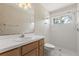 Bathroom featuring an oak vanity with a large mirror and a tiled shower with a glass door at 580 Mercers Fernery Rd., Deland, FL 32720