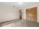 Bedroom featuring neutral paint and carpet, a closet, and doorway leading to other rooms at 580 Mercers Fernery Rd., Deland, FL 32720