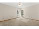 Neutral bedroom with carpet flooring, ceiling fan, and sunlit windows provides ample natural light at 580 Mercers Fernery Rd., Deland, FL 32720