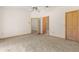 Neutral bedroom featuring an overhead fan, carpeted floors, and multiple doorways leading to other rooms at 580 Mercers Fernery Rd., Deland, FL 32720