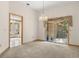 Open dining space with chandelier and sliding glass doors to the patio at 580 Mercers Fernery Rd., Deland, FL 32720