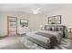 Well-lit main bedroom features a neutral color palette with a view into the ensuite bathroom at 580 Mercers Fernery Rd., Deland, FL 32720