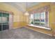 Bright dining area with a window seat and a decorative chandelier and tile flooring at 602 Catalina Ct, Lady Lake, FL 32159