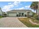 Charming single-story home with a two-car garage, a well-manicured lawn, and a paved driveway at 602 Catalina Ct, Lady Lake, FL 32159