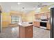 Bright kitchen with island, tile floors, and appliances, perfect for cooking and entertaining at 602 Catalina Ct, Lady Lake, FL 32159