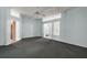 Open-concept living room with carpet, ceiling fan, columns, and view of the front entryway at 602 Catalina Ct, Lady Lake, FL 32159