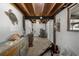 Unfinished basement with exposed wooden ceiling beams and concrete floors at 6490 Se 180Th Avenue Rd, Ocklawaha, FL 32179