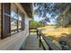 Exterior view of a wooden deck overlooking marshland at 6490 Se 180Th Avenue Rd, Ocklawaha, FL 32179