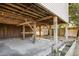 View of concrete pad beneath stilt house with wooden beams and storage shed at 6490 Se 180Th Avenue Rd, Ocklawaha, FL 32179