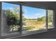 View from a window overlooking a scenic marshland with trees and a blue sky at 6490 Se 180Th Avenue Rd, Ocklawaha, FL 32179