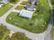 Aerial view of home with a large manicured lawn, nearby street, and surrounding neighborhood at 701 Brigadoon Cir, Leesburg, FL 34788