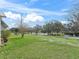 Large backyard with lush green grass and a view of a lake, showcasing outdoor space at 701 Brigadoon Cir, Leesburg, FL 34788