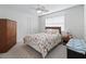 Well-lit bedroom features a window, closet, and ceiling fan, perfect for relaxing at 701 Brigadoon Cir, Leesburg, FL 34788