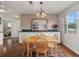 Inviting dining space featuring hard wood floors, an area rug and a decorative painting at 701 Brigadoon Cir, Leesburg, FL 34788