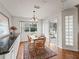 Bright dining area with wood flooring, a table set, and a view to the outside at 701 Brigadoon Cir, Leesburg, FL 34788