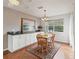 Charming dining room featuring a wood table set, area rug, and natural light at 701 Brigadoon Cir, Leesburg, FL 34788