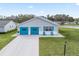 Attractive single-story home with a two-car garage, shutters and lovely lawn at 701 Brigadoon Cir, Leesburg, FL 34788