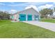 Single-story home with a two-car garage, shutters and a well-maintained lawn at 701 Brigadoon Cir, Leesburg, FL 34788