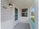 Front porch with an exterior light and glass-paneled front door at 701 Brigadoon Cir, Leesburg, FL 34788