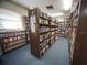 A cozy library with floor-to-ceiling bookshelves filled with a variety of books at 701 Brigadoon Cir, Leesburg, FL 34788