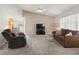 Comfortable living room with carpet, ceiling fan, a large window, and neutral tones at 701 Brigadoon Cir, Leesburg, FL 34788