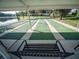 Enjoy a game of shuffleboard on the community court with waterfront views; relaxing bench available at 701 Brigadoon Cir, Leesburg, FL 34788