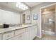 Bathroom featuring double sinks, granite countertops, and Mickey Mouse decor at 7581 Oak Spring Ln, Davenport, FL 33837