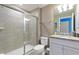 Bathroom with a glass-enclosed shower and granite vanity top at 7581 Oak Spring Ln, Davenport, FL 33837