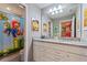 Bathroom featuring double sinks with granite countertops and a playful Mario shower curtain at 7581 Oak Spring Ln, Davenport, FL 33837