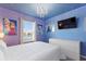 Bedroom with a window view and Frozen-themed decor and wall art at 7581 Oak Spring Ln, Davenport, FL 33837