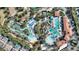 Overhead view of the community pool with a lazy river, sun loungers, and tropical landscaping at 7581 Oak Spring Ln, Davenport, FL 33837