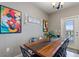 Dining room with large wooden table and views of the pool area through the glass door at 7581 Oak Spring Ln, Davenport, FL 33837