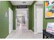 Welcoming hallway with tile floors, green walls, and views into the living spaces at 7581 Oak Spring Ln, Davenport, FL 33837