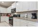 Modern kitchen with white cabinetry, granite countertops, and stainless steel appliances at 7581 Oak Spring Ln, Davenport, FL 33837