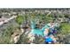 Overhead perspective of the neighborhood lazy river, complemented by lush greenery and lounge areas at 7581 Oak Spring Ln, Davenport, FL 33837