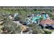 A community playground is set amongst tropical landscaping, a pool, and buildings in the background at 7581 Oak Spring Ln, Davenport, FL 33837