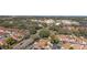 A clear aerial view of houses, roads, and a commercial area in the distance at 922 Cancun Ct, The Villages, FL 32159