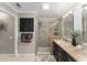 Beautiful bathroom with a glass shower, double sinks with granite counters, and dark cabinetry at 922 Cancun Ct, The Villages, FL 32159