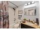 Cozy bathroom features a shower-tub combo, dark fixtures, and a granite-topped vanity at 922 Cancun Ct, The Villages, FL 32159