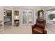 Inviting foyer with tile floors, a glass-paned door, and a comfortable leather armchair at 922 Cancun Ct, The Villages, FL 32159